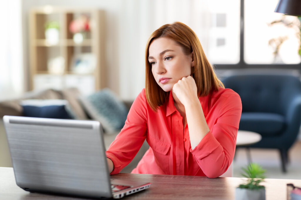 Thoughtful woman at her laptop 2 New Year, New Resolution: Keep Your Business Safe from Cyber Threats